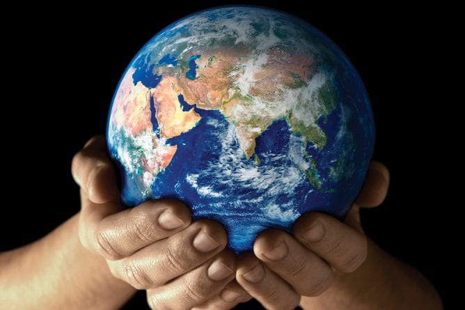hands cradling the planet earth