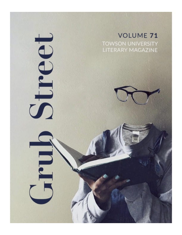 Cover of Volume 71. A person is holding a book and wearing glasses. The person's head is invisible.
