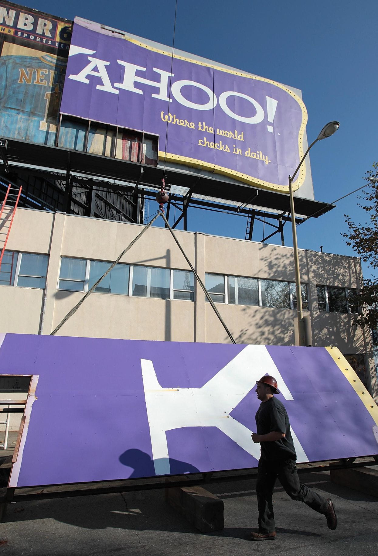 ​A worker carts away a piece of a Yahoo billboard in San Francisco in 2011.