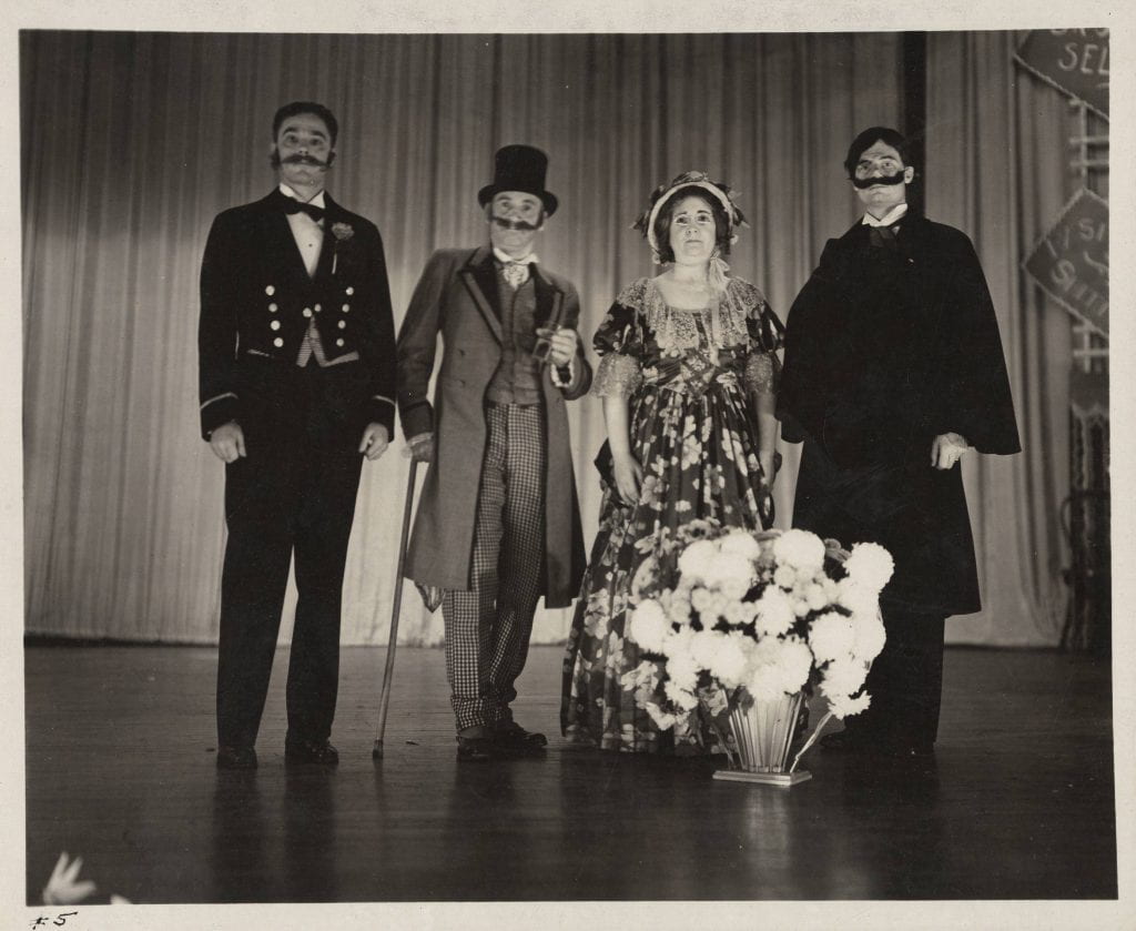 From l-r: Joe West, Science teacher, as Richard Blair; Curt Walther, Geography and Social Studies professor, as The Baron of Amusement; M. Theresa Wiedefeld as perhaps Mlle. Zara; and Compton Crook, Biology professor as the villain, Egbert Van Horn.