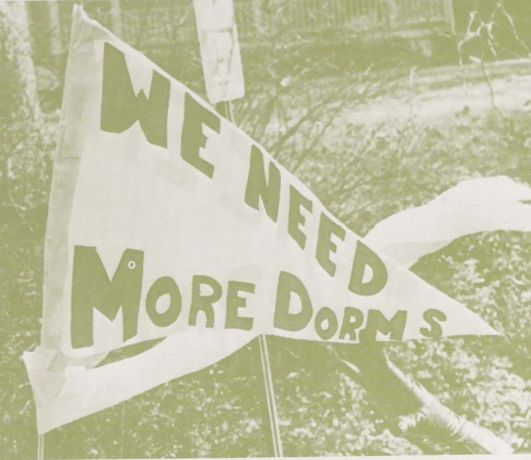 A flag with the words "We need more dorms"