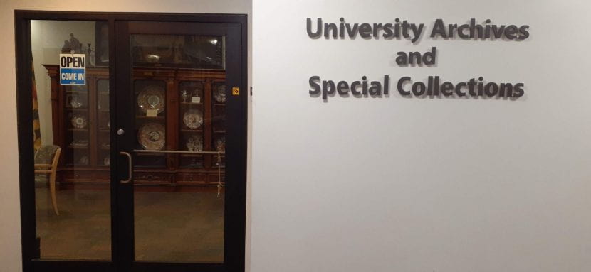 Front door of department with sign on wall that says University Archives and Special Collections